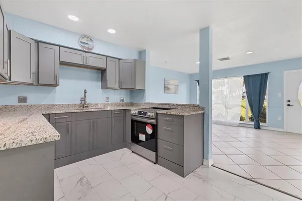 a kitchen with stainless steel appliances granite countertop a stove and a sink