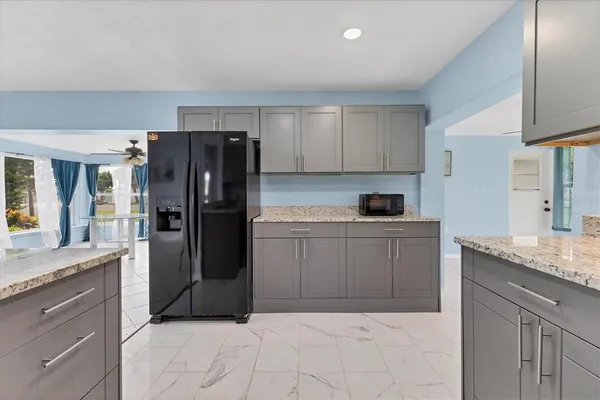 a kitchen with a refrigerator and cabinets