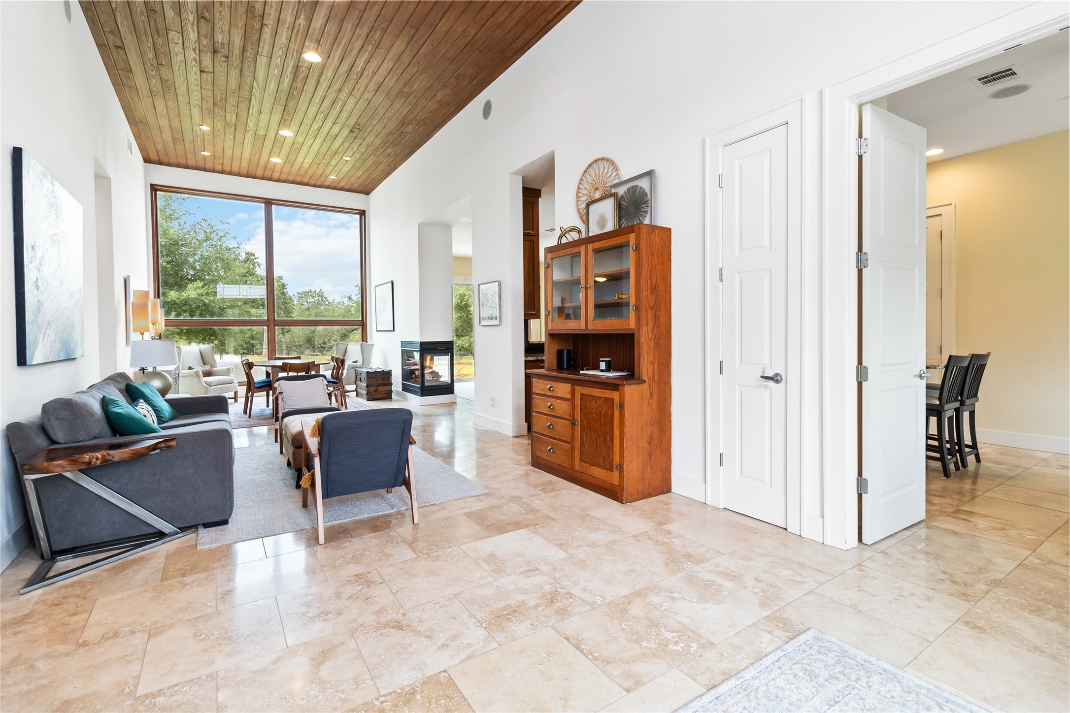 129 Powder Horn Road Bastrop, TX 78602 - Photo 5 of 27 Living area featuring wood ceiling, recessed lighting, and a multi sided fireplace