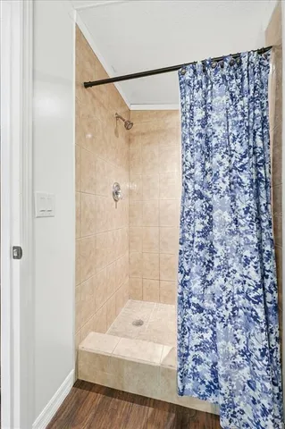 a bedroom with a bed and flat tv screen on dresser