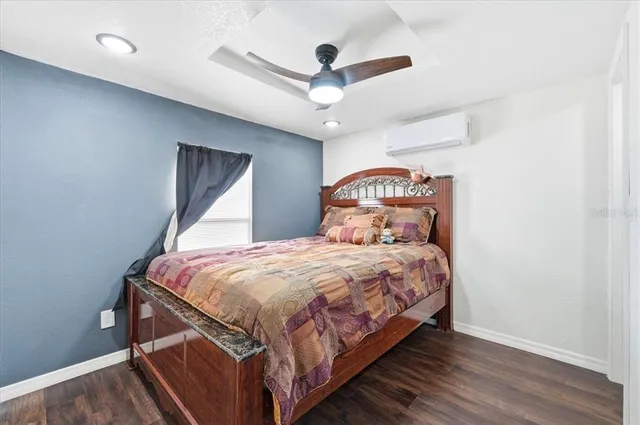 a bedroom with a large bed and a chandelier