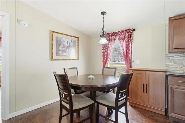 a bedroom with a bed a chandelier and a window