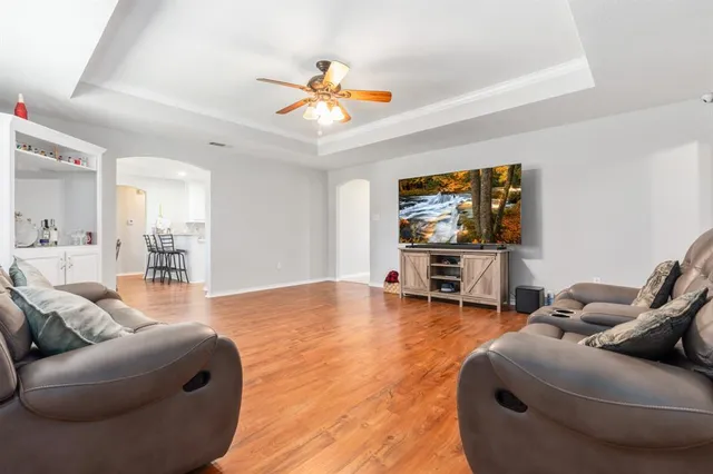 a living room with furniture and a flat screen tv