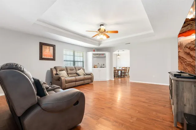 a living room with furniture and wooden floor