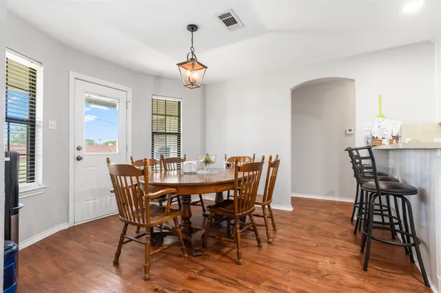 a view of a dining room with furniture and wooden floor