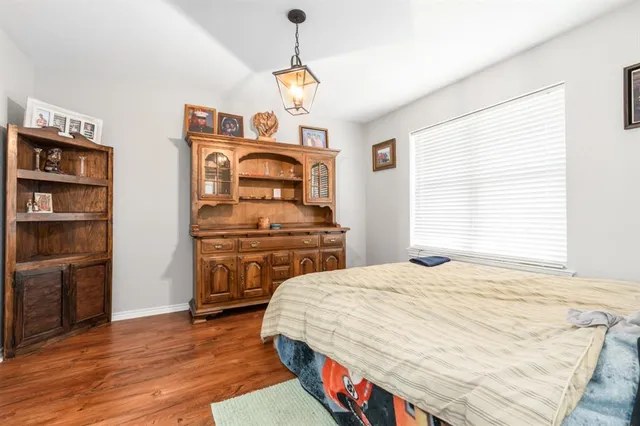 a bedroom with a bed and a television