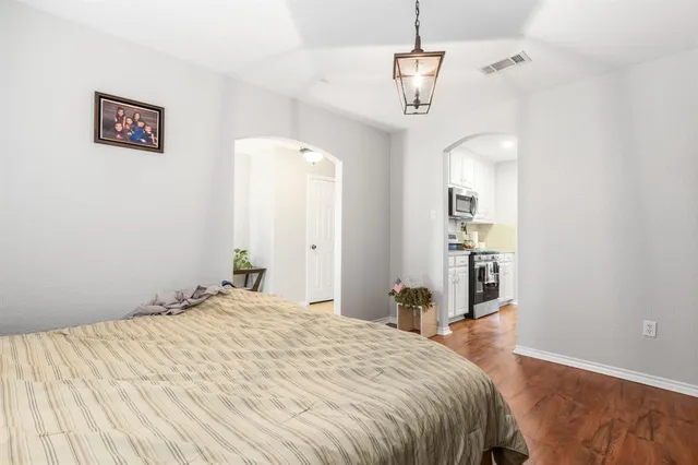 a bedroom with a bed and a chandelier