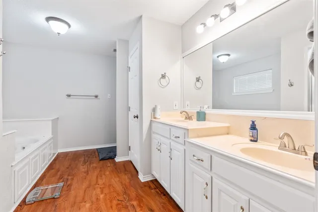 a spacious bathroom with a double vanity sink and mirror