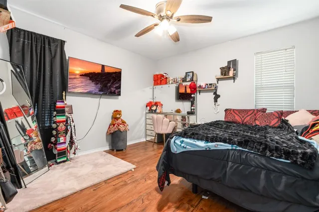 a bedroom with furniture and a flat screen tv