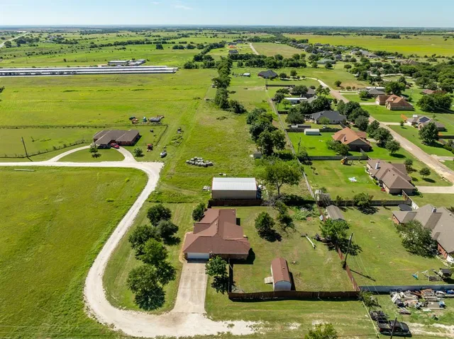 an aerial view of a houses with outdoor space