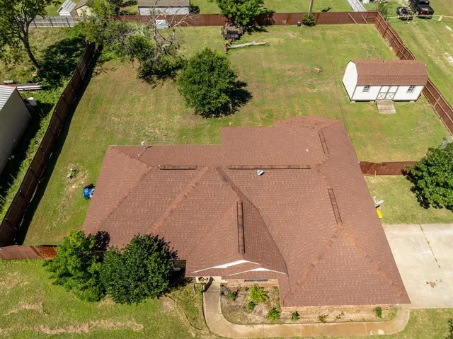 an aerial view of a house with a yard