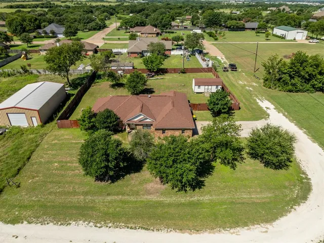 an aerial view of residential houses with outdoor space and river