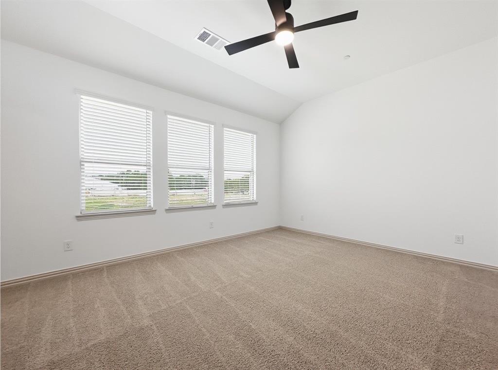 2837 Bluejack Road McKinney, TX 75071 - Photo 17 of 40 an empty room with ceiling fan and windows