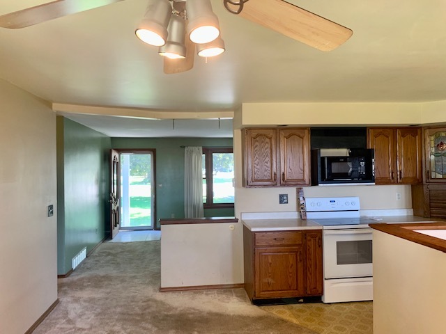3272 River Road Kankakee, IL 60901 - Photo 5 of 15 a kitchen with kitchen island granite countertop a sink cabinets and stainless steel appliances