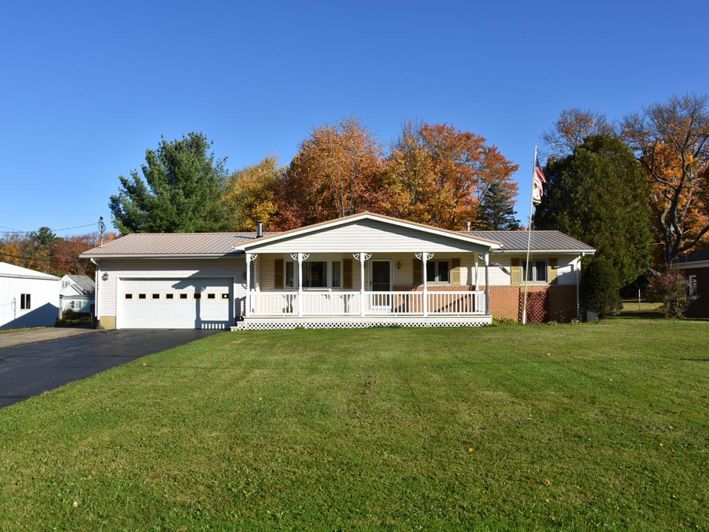 a front view of a house with a garden