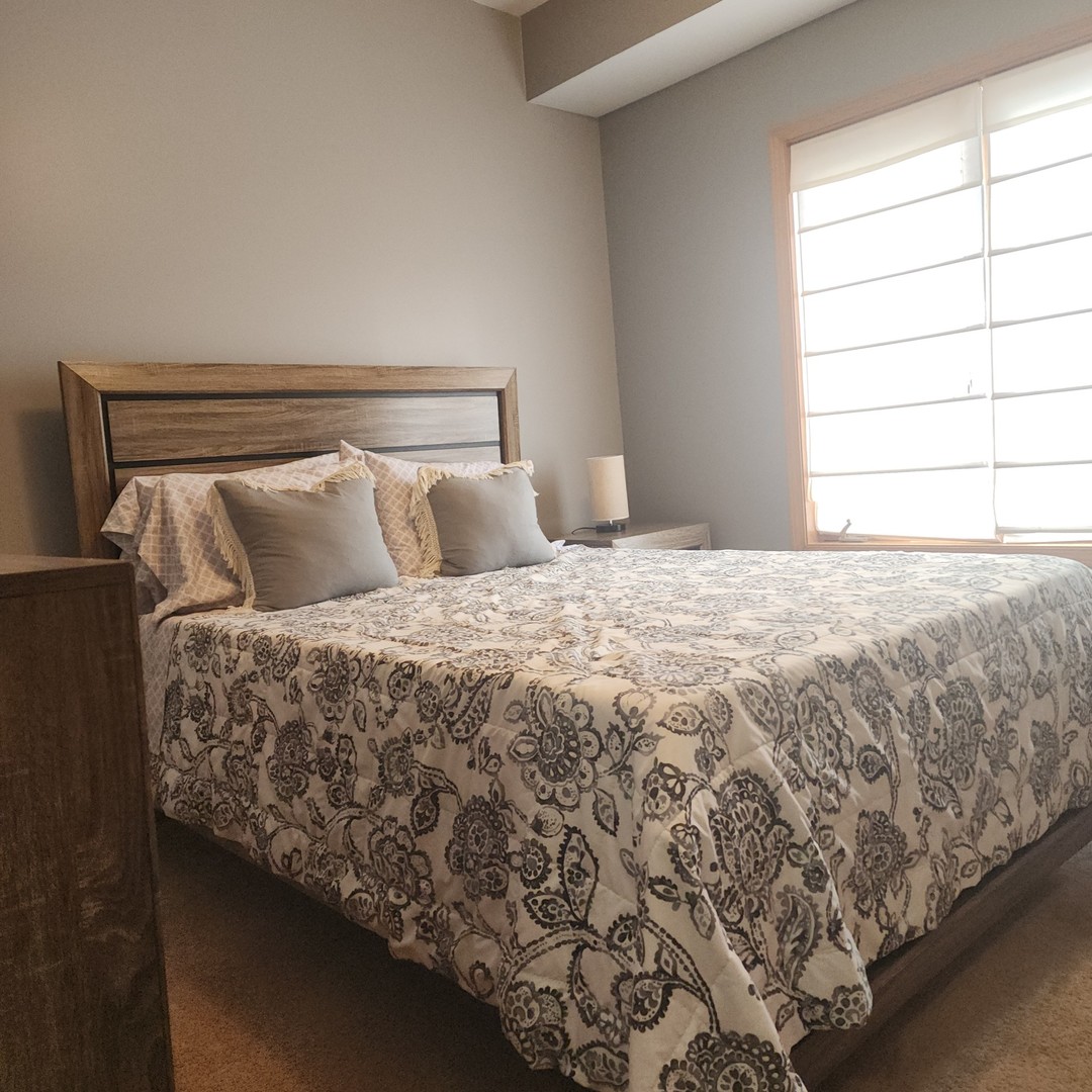 10624 Central Avenue, Unit 2B Chicago Ridge, IL 60415 - Photo 8 of 16 a large bed sitting in a bedroom next to a window