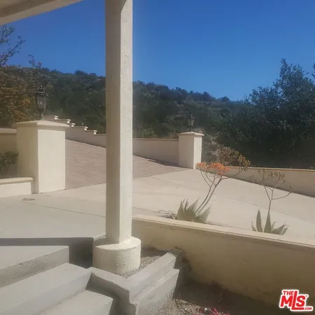 a view of a yard from a balcony