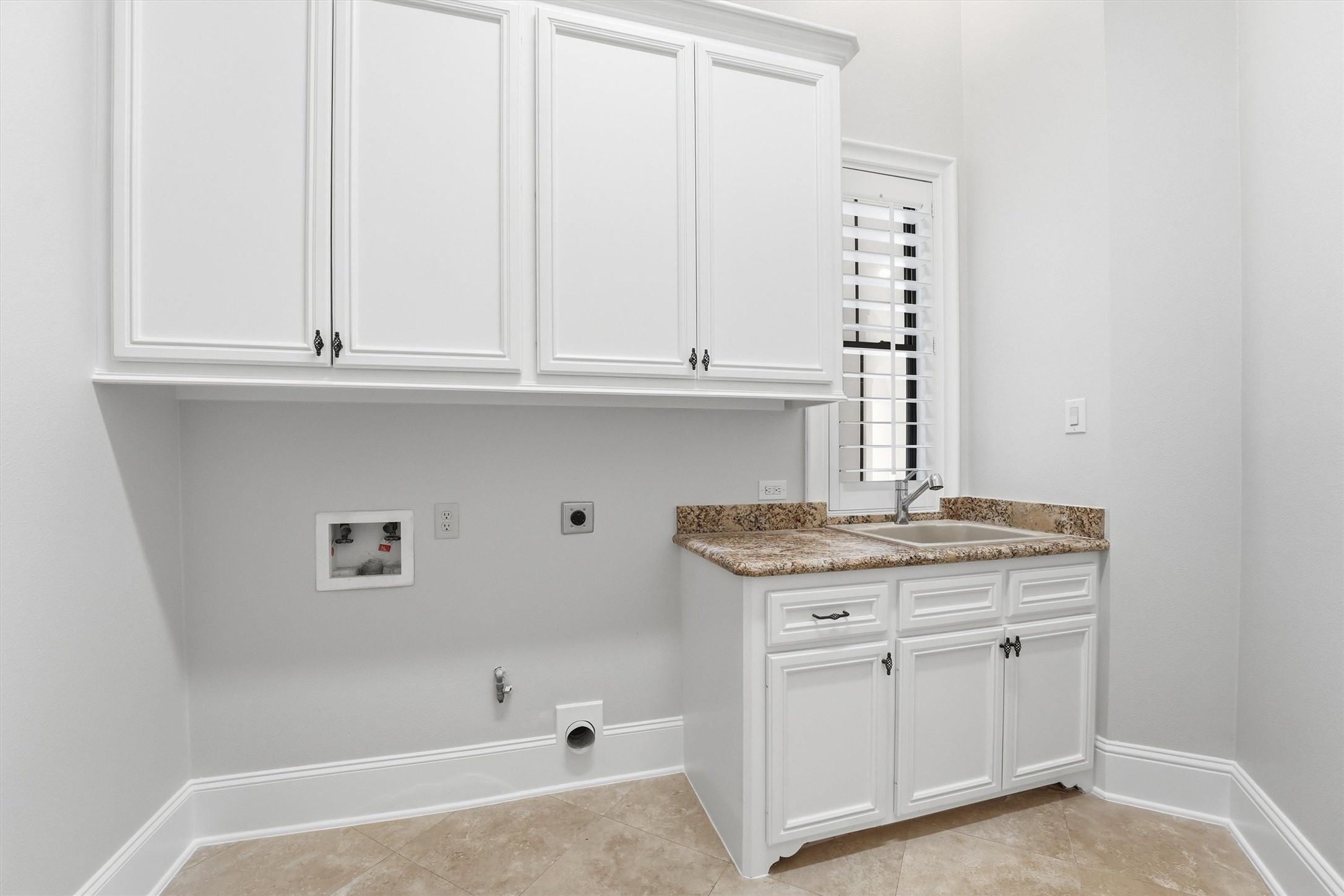 70 Quail Rock Place The Woodlands, TX 77381 - Photo 25 of 46 a kitchen with granite countertop white cabinets and a stove