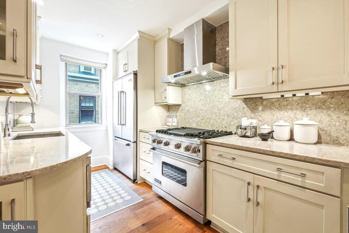1910 Kalorama Road Northwest, Unit 403 Washington, DC 20009 - Photo 12 of 52 a kitchen with stainless steel appliances granite countertop a stove and a sink