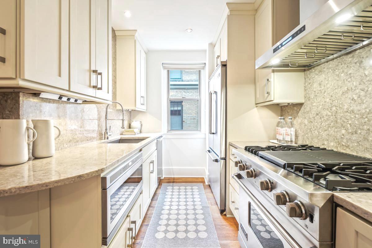 1910 Kalorama Road Northwest, Unit 403 Washington, DC 20009 - Photo 13 of 52 a kitchen with granite countertop a stove and a sink