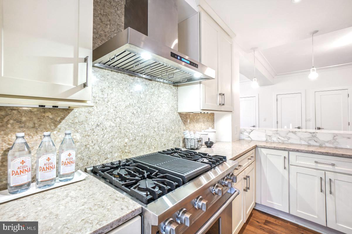 1910 Kalorama Road Northwest, Unit 403 Washington, DC 20009 - Photo 15 of 52 a kitchen with stainless steel appliances granite countertop a stove and a sink