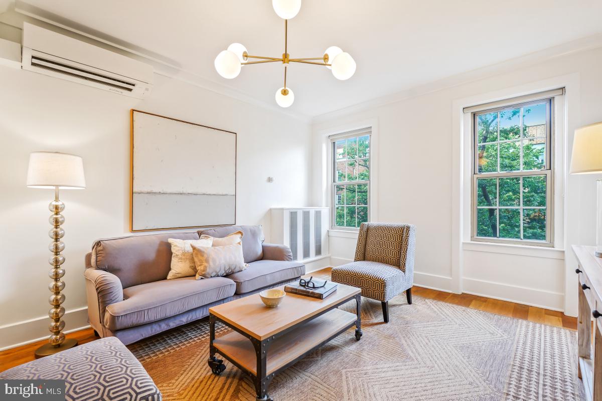 1910 Kalorama Road Northwest, Unit 403 Washington, DC 20009 - Photo 17 of 52 a living room with furniture a window and a lamp