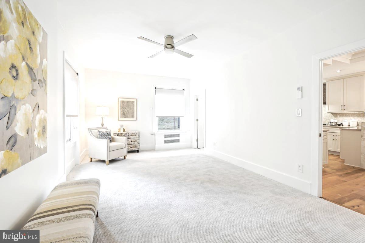 1910 Kalorama Road Northwest, Unit 403 Washington, DC 20009 - Photo 25 of 52 a spacious bedroom with a bed and a chandelier