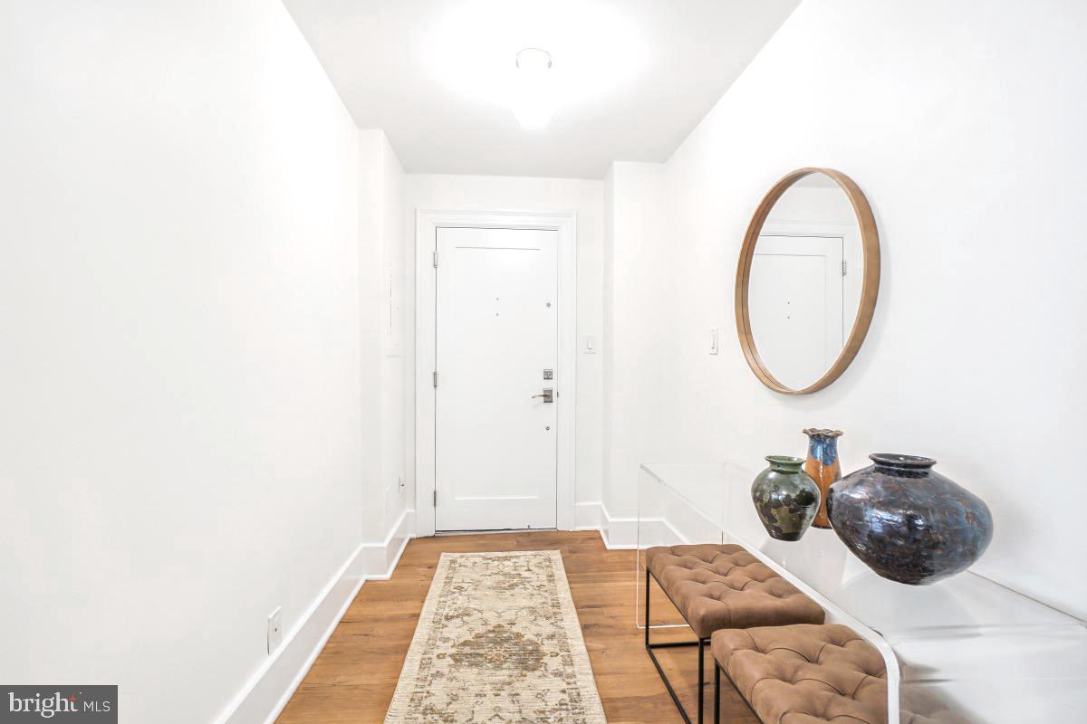 1910 Kalorama Road Northwest, Unit 403 Washington, DC 20009 - Photo 5 of 52 a bed room with a bed and a mirror