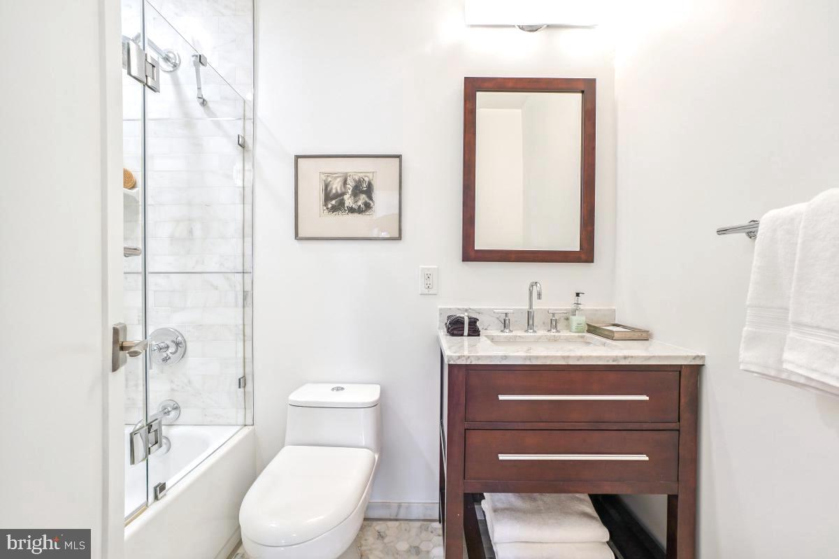1910 Kalorama Road Northwest, Unit 403 Washington, DC 20009 - Photo 6 of 52 a bathroom with a toilet a sink and mirror
