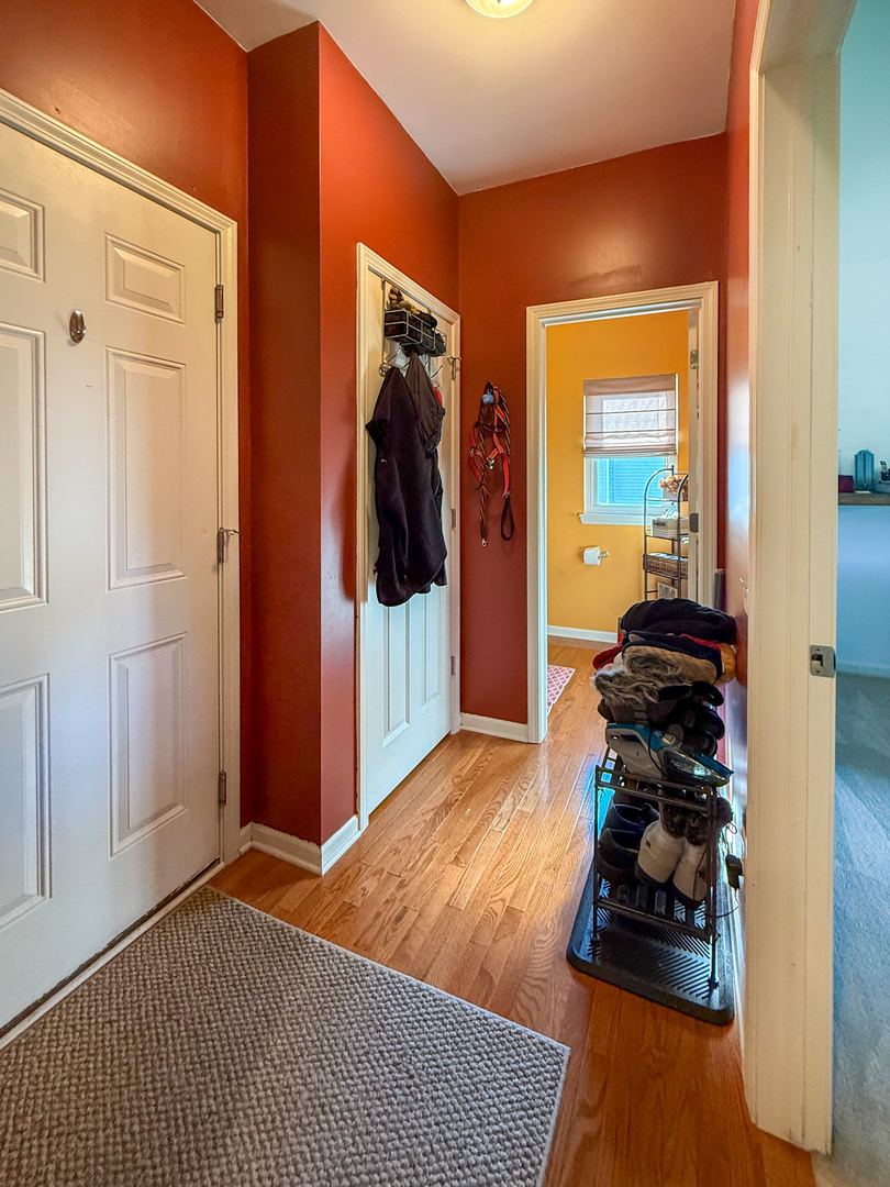 445 East Becker Place Sycamore, IL 60178 - Photo 12 of 27 a living room with a bed and a mirror