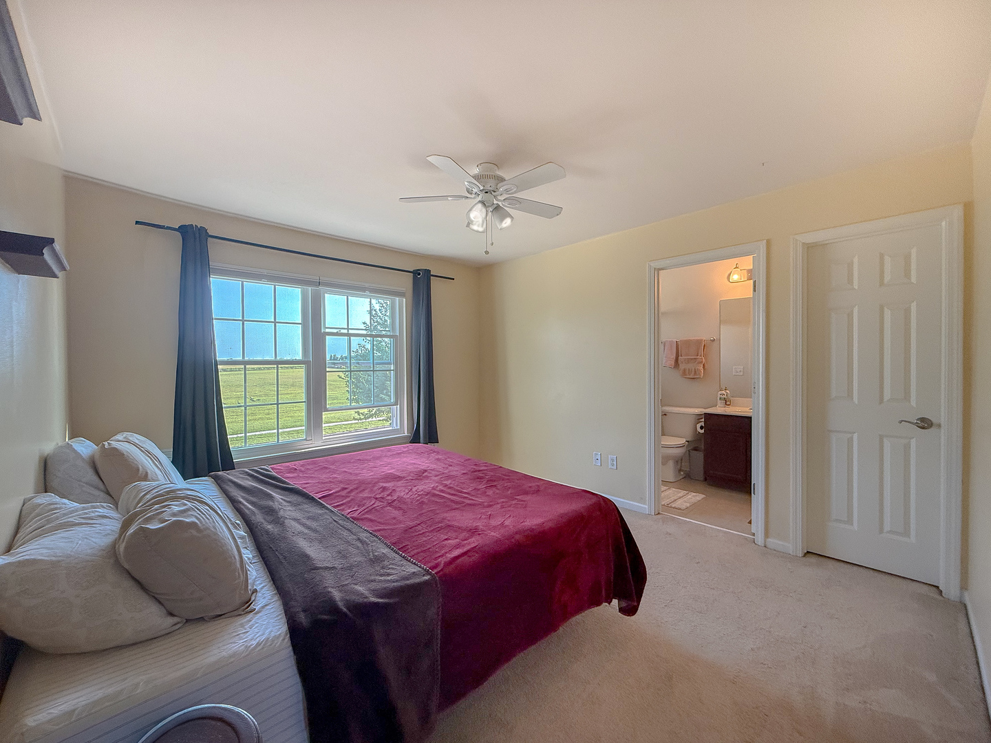 445 East Becker Place Sycamore, IL 60178 - Photo 18 of 27 a bedroom with a bed and a chandelier