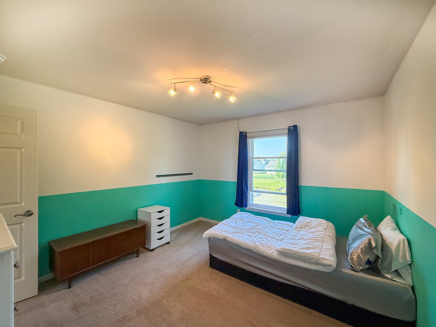 445 East Becker Place Sycamore, IL 60178 - Photo 19 of 27 a bedroom with a bed and a window