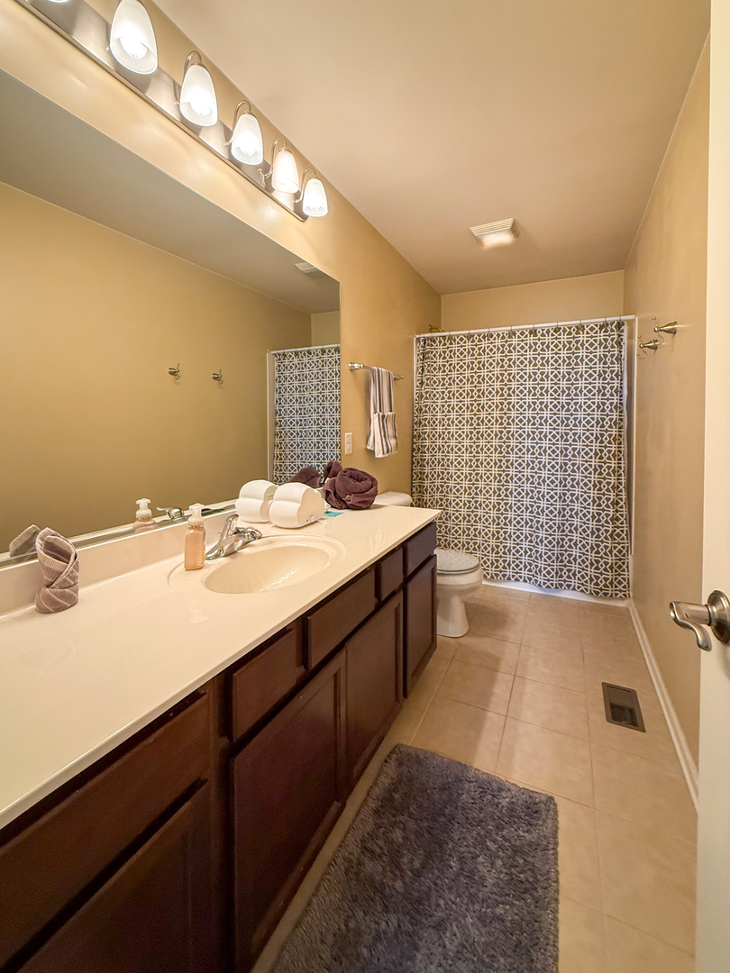 445 East Becker Place Sycamore, IL 60178 - Photo 20 of 27 a spacious bathroom with a sink a large mirror and shower
