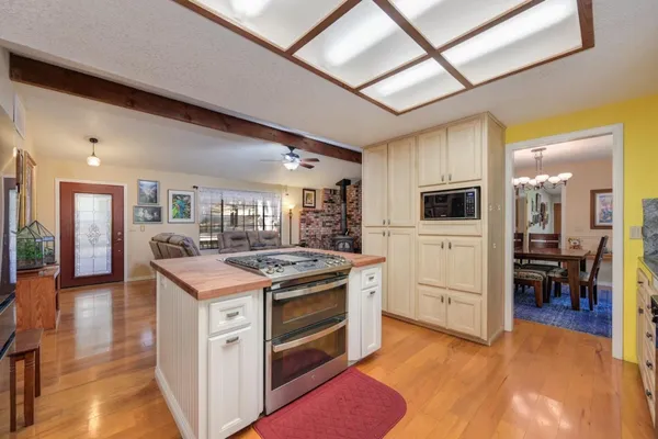 a view of kitchen with stainless steel appliances granite countertop refrigerator sink and cabinets