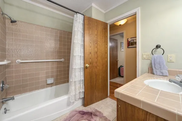 a view of a patio with table and chairs with wooden floor and fence