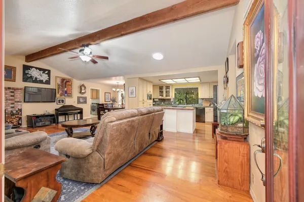a living room with furniture a rug and a chandelier