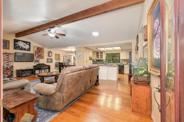 a living room with furniture a rug and a chandelier