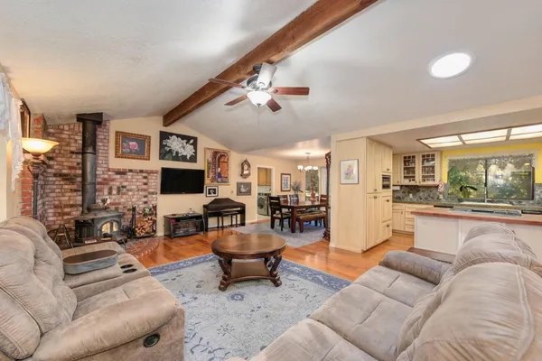 a living room with fireplace furniture and a rug
