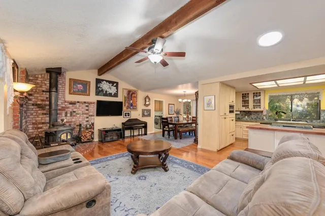 a living room with fireplace furniture and a rug