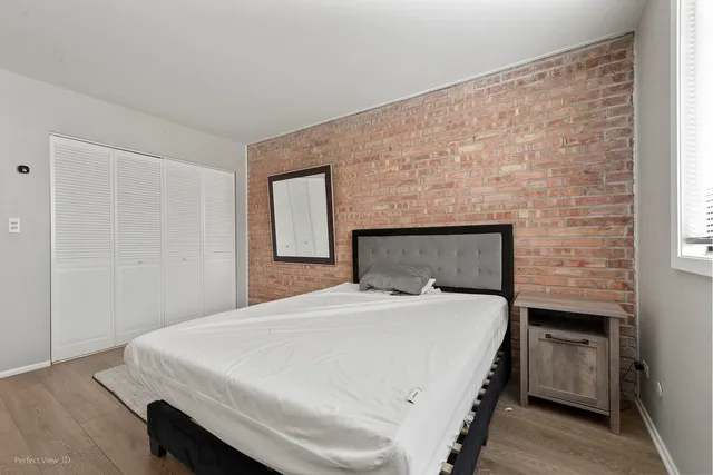 a bedroom with a bed and a night stand