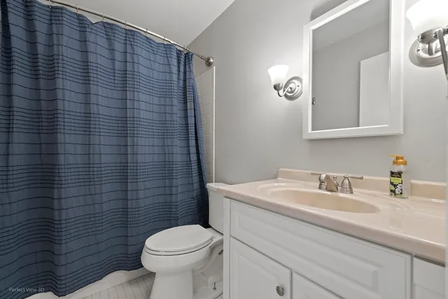 a bathroom with a sink a toilet and mirror
