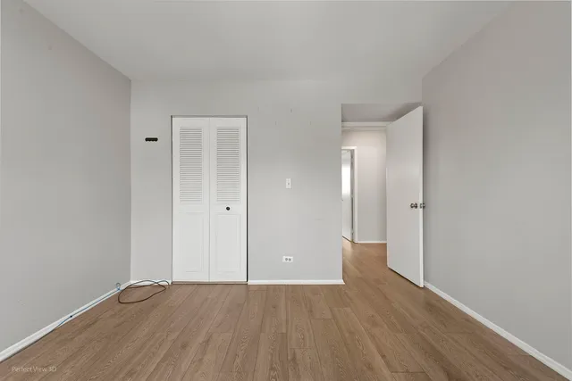 a view of an empty room and wooden floor