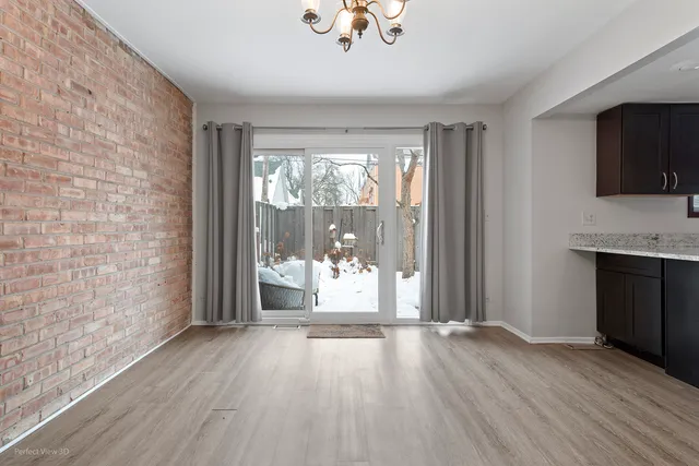 a view of a room with wooden floor and a window