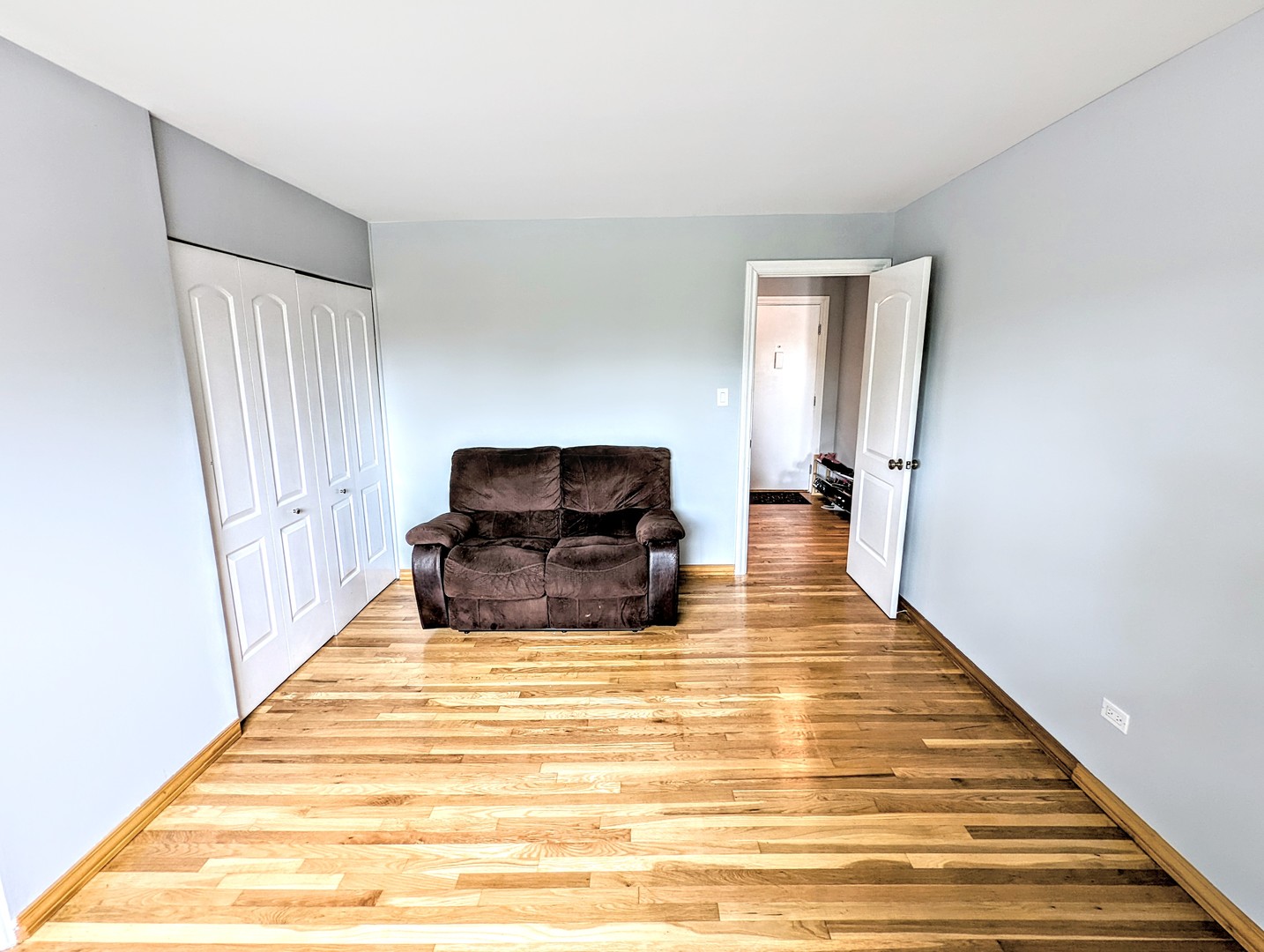 9418 Dee Road, Unit 203C Des Plaines, IL 60016 - Photo 12 of 24 a living room with furniture and a wooden floor