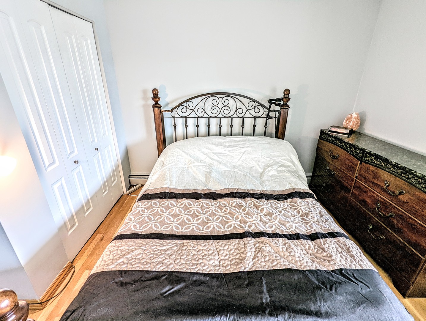 9418 Dee Road, Unit 203C Des Plaines, IL 60016 - Photo 16 of 24 a bedroom with a bed rug and wooden floor