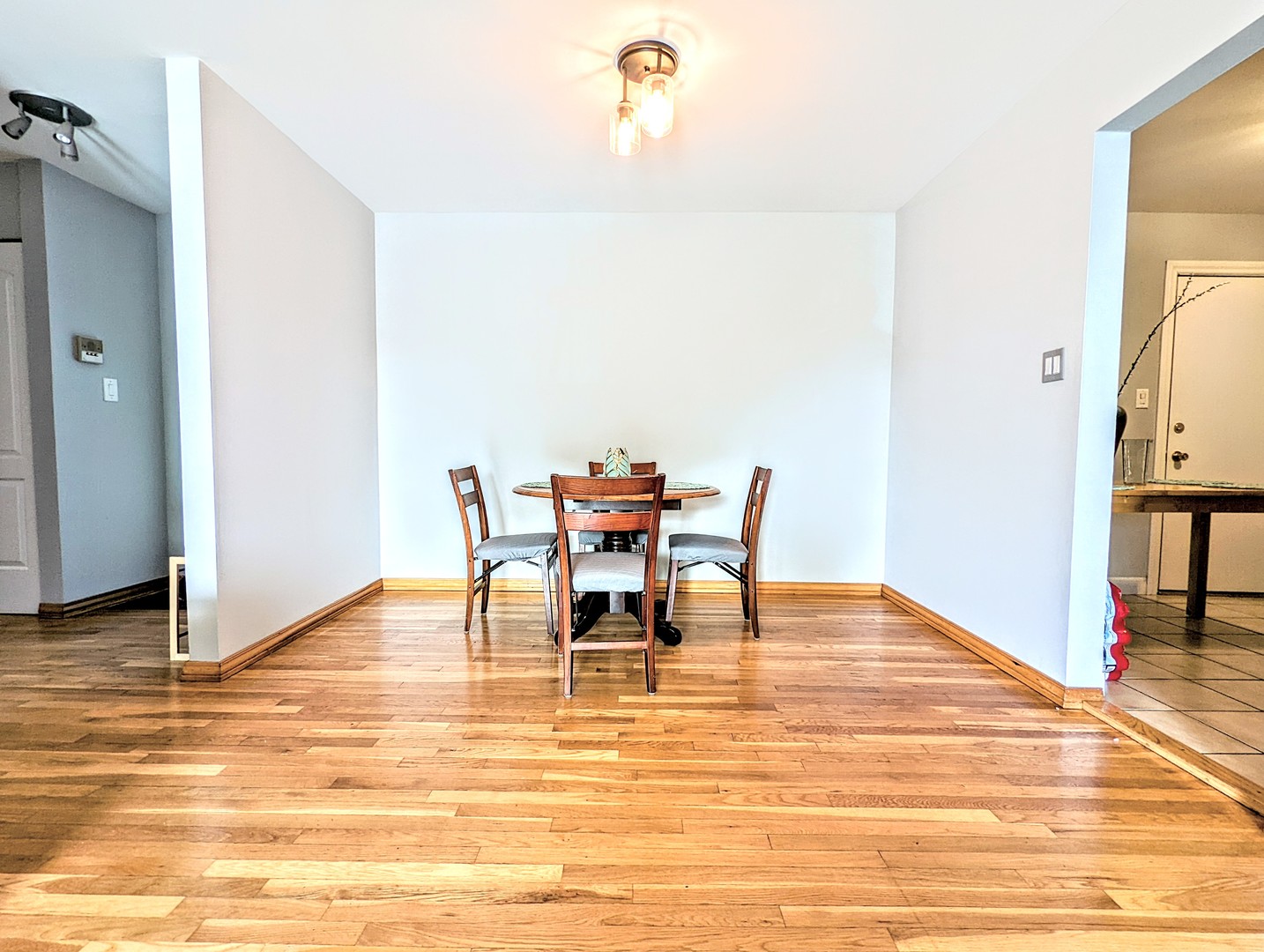 9418 Dee Road, Unit 203C Des Plaines, IL 60016 - Photo 17 of 24 a dining room with furniture and wooden floor