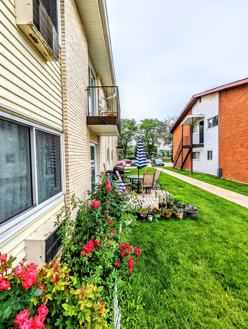 9418 Dee Road, Unit 203C Des Plaines, IL 60016 - Photo 22 of 24 a view of a house with a backyard and sitting area