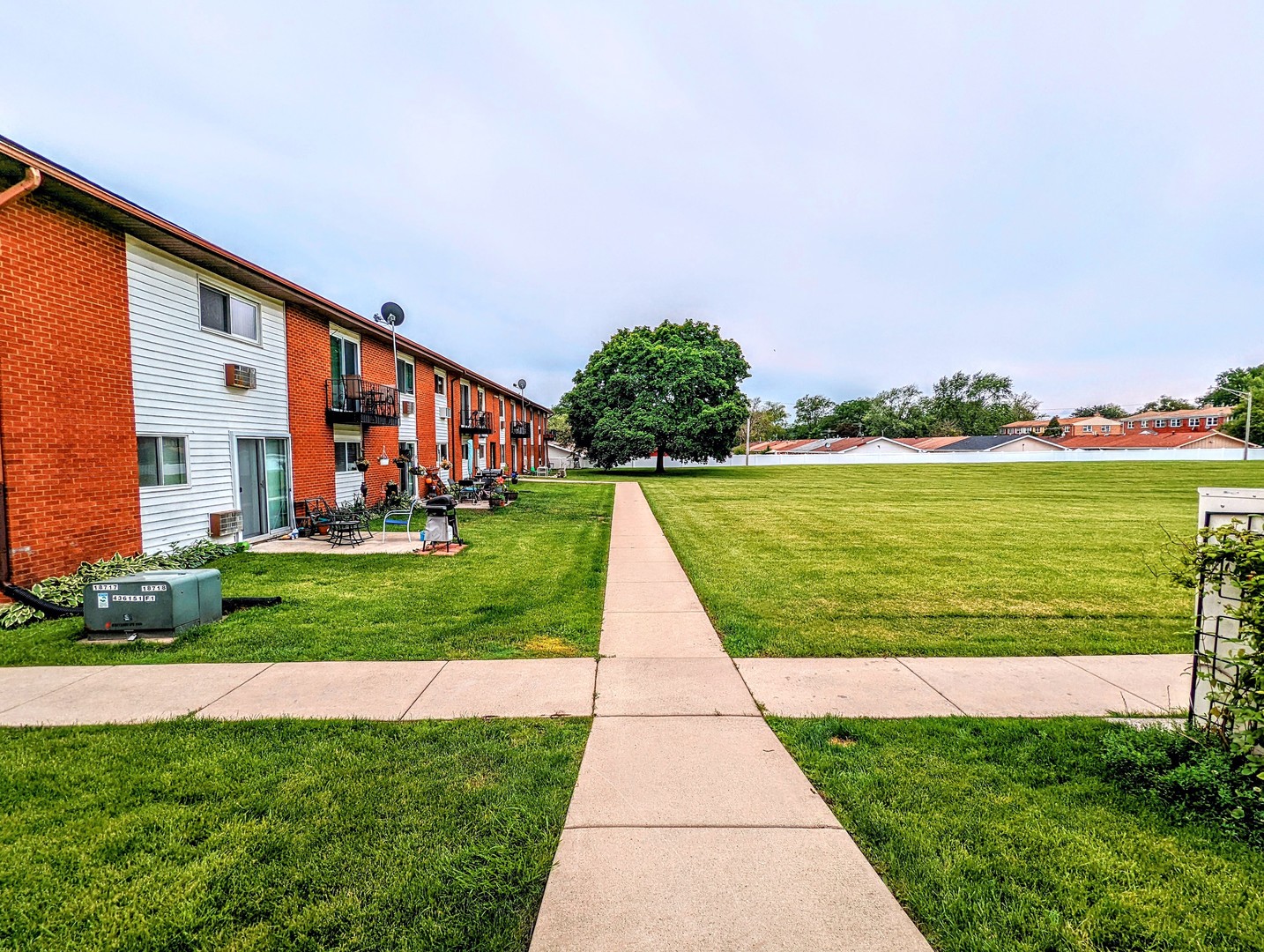 9418 Dee Road, Unit 203C Des Plaines, IL 60016 - Photo 23 of 24 a view of building with garden