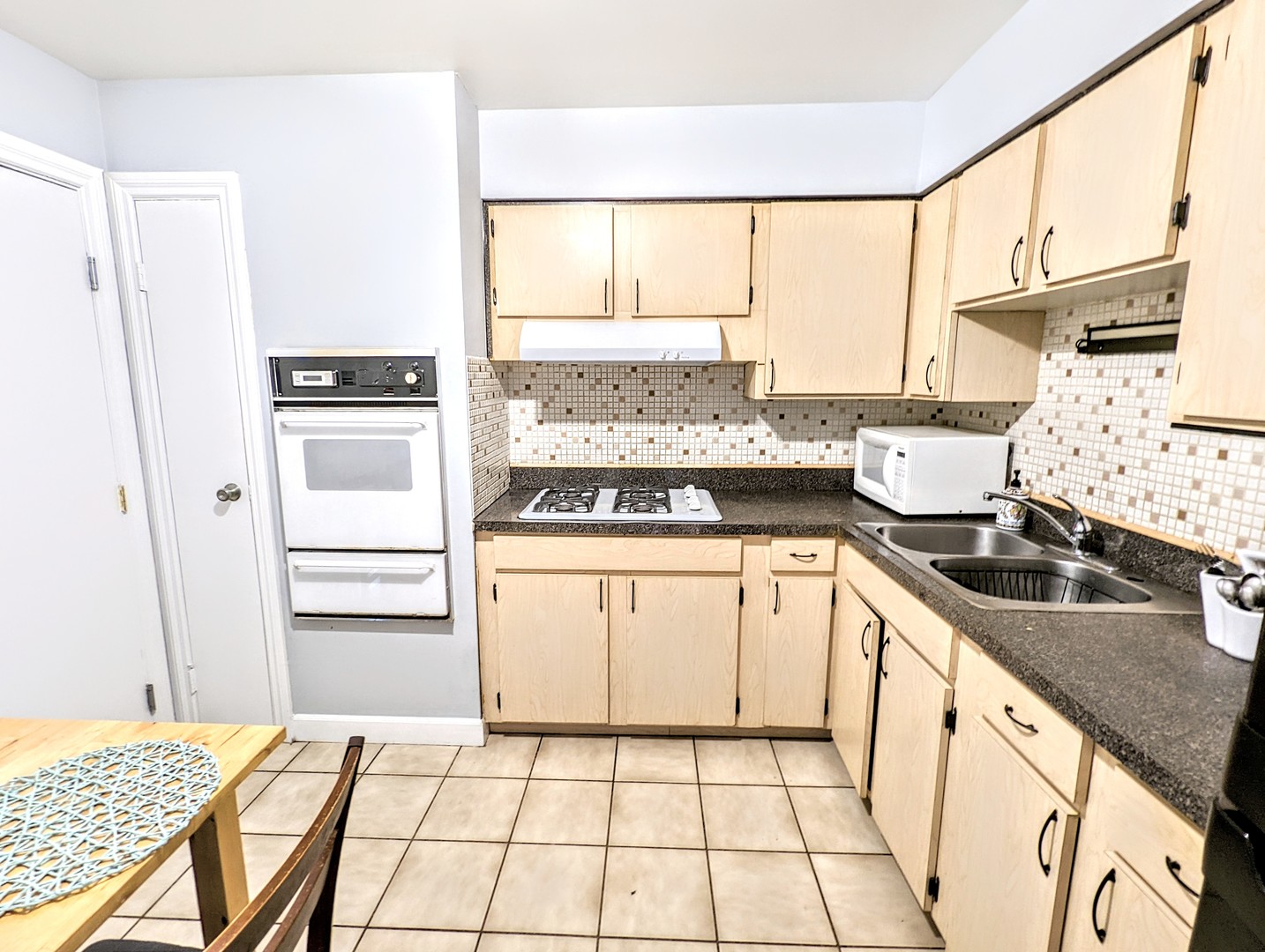 9418 Dee Road, Unit 203C Des Plaines, IL 60016 - Photo 4 of 24 a kitchen with a sink stove and refrigerator