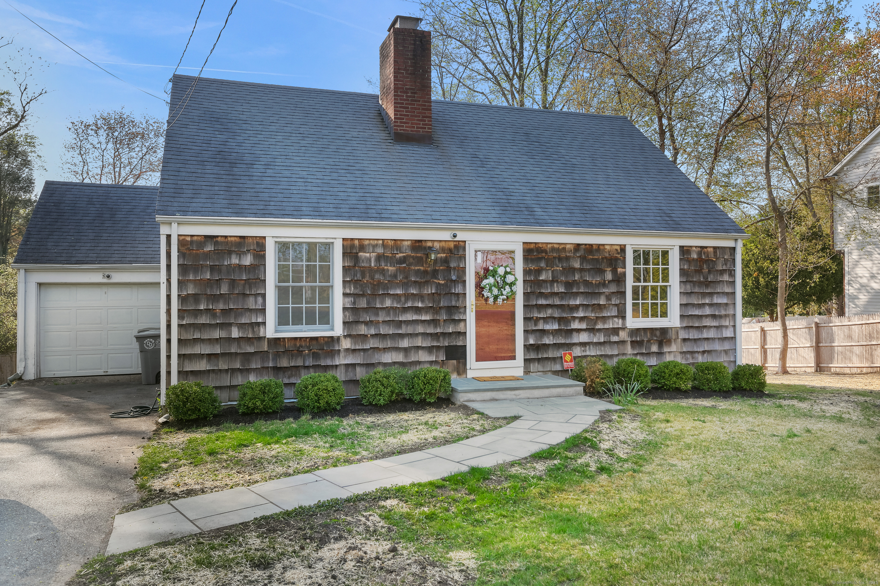 Charming sunny cape with lovely slate walkway and new storm door.